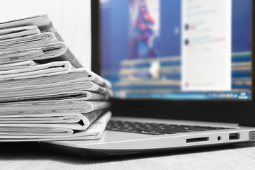 Newspapers and Laptop. Different Concepts for News - Social Network or Traditional Tabloid...