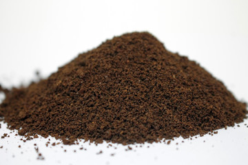  A pile of ground coffee on a white background.