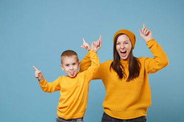 Woman in yellow clothes have fun posing with cute child baby boy 4-5 years old. Mommy little kid...