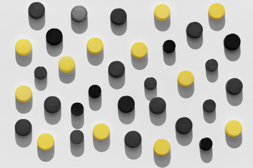 Plastic bottle caps background with black and yellow random pattern on white background
