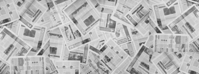 Long horizontal banner with lots of old newspapers on horizontal surface. Background texture, top...