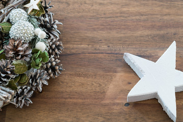 Christmas decoration on a rustic brown wooden background with a white wood star