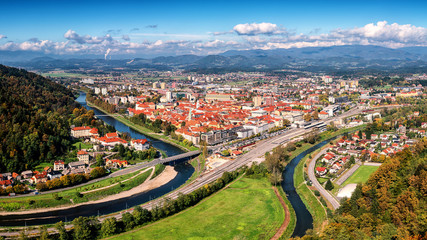 City of Celje in Slovenia, Styria, panoramic aerial view from old castle ancient walls. Amazing landscape with town in Lasko valley, river Savinja and blue sky with clouds, outdoor travel background