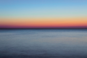 Naklejka na ściany i meble Langzeitbelichtung der Nordsee am Strand der Insel Sylt nach Sonnenuntergang