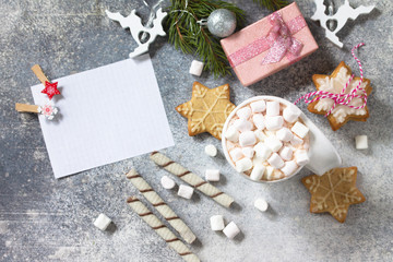 Fototapeta na wymiar Christmas dessert or breakfast. A cup of hot cocoa with marshmallows and Christmas baking on a stone countertop. Top view on a flat background.