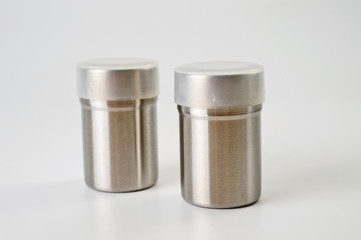 Metal containers with holes in the lids for salt and pepper, for serving the kitchen table