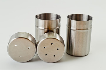 Metal containers with holes in the lids for salt and pepper, for serving the kitchen table