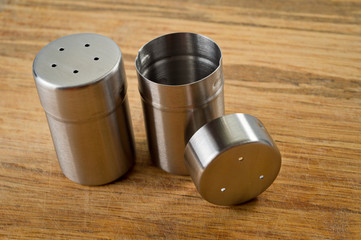 Metal containers with holes in the lids for salt and pepper, for serving the kitchen table