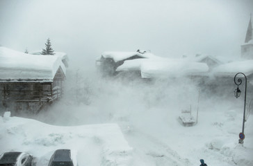 Heavy snow storm at Val d'Isere, Savoie of France. Buildings covered with snow during hard winter...