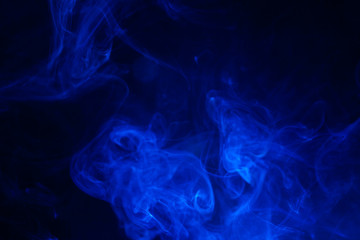Blue smoke on black background.