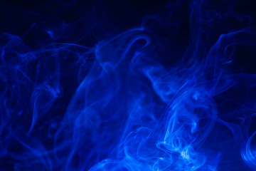 Blue smoke on black background.