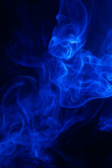 Blue smoke on black background.