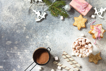Christmas dessert or breakfast. A cup of hot cocoa with marshmallows and Christmas baking on a stone countertop. Top view on a flat background. Copy space.