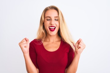 Young beautiful woman wearing red t-shirt standing over isolated white background excited for success with arms raised and eyes closed celebrating victory smiling. Winner concept.