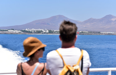 Couple watching Lanzarote Island from the ferry, Canary Islands, Spain