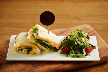 Panini sandwich with salad on plate 
