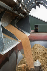 Cattlefeed. Feedmixer. Farming. Netherlands. Dumping roughage in feedmixer