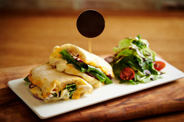 Panini sandwich with salad on plate 