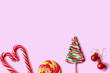 Christmas candies and sweets on a pink background. Minimal creative design.