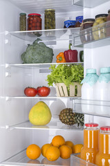 Fototapeta na wymiar Open fridge full of fresh fruits and vegetables