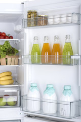 Open fridge full of fresh fruits and vegetables