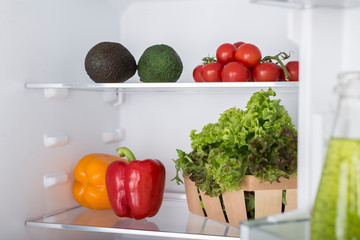Open fridge full of fresh fruits and vegetables