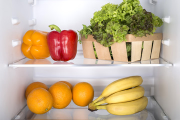 Open fridge full of fresh fruits and vegetables