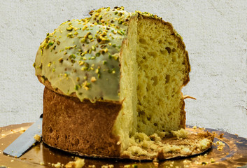 an exquisite Italian Christmas cake, panettone covered with pistachio cream