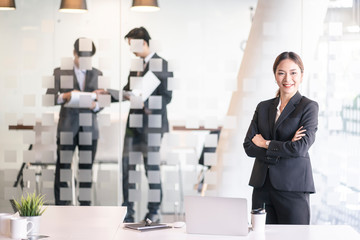 Asian confident business woman arms crossed in the working space.