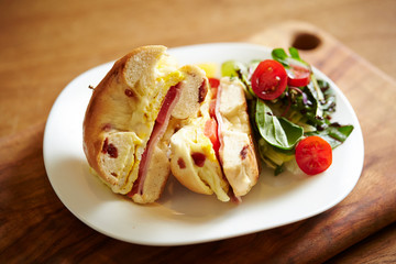 Bagel sandwich and salad on plate