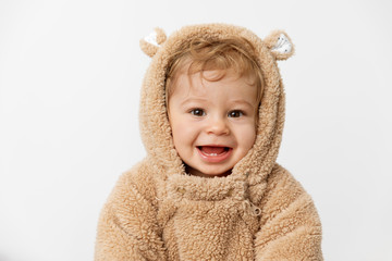 Cute smiling baby wearing hooded bear suit