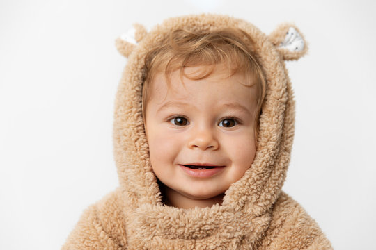 Portrait of smiling baby in hooded bear suit