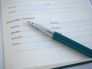 Important contact,Doctor,Dentist,Solicitor and Other page in diary with pen.