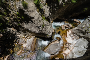 River in the mountains with a fast current and waterfalls. 