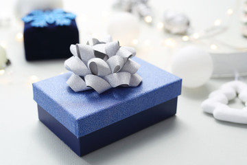 Christmas gift. Christmas composition in blue and silver colors. Elegant blue gift and silver bow