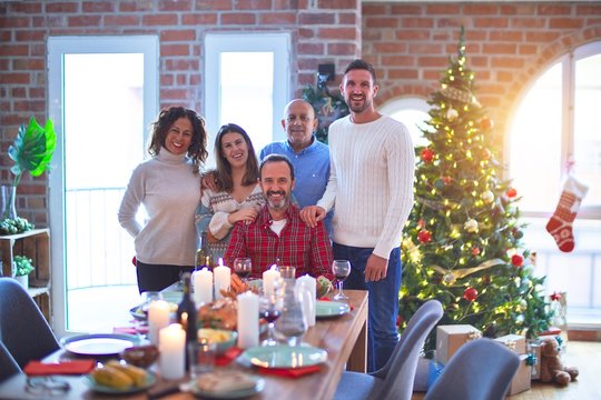 Beautiful family smiling happy and confident. Standing and posing with tree celebrating Christmas at home