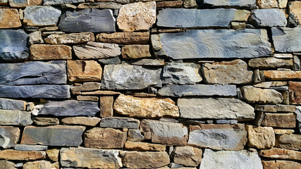 Old wall from stones of various shapes