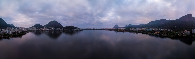 Full 360 degrees aerial panorama of the city lake in Rio de Janeiro on an overcast early morning with the Corcovado mountain and hints of blue and purple in the sky