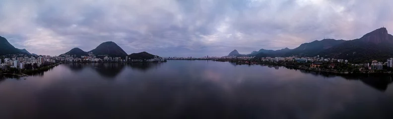 Fotobehang Full 360 degrees aerial panorama of the city lake in Rio de Janeiro on an overcast early morning with the Corcovado mountain and hints of blue and purple in the sky © Maarten Zeehandelaar