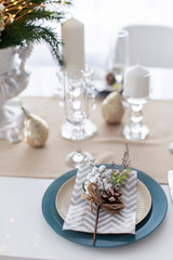 set of dishes table setting for christmas home dinner new year. blue white Plate cutlery cozy family restaurant pine cone festive decoration