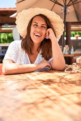 Young beautiful woman sitting at tropical restaurant enjoying summer vacation