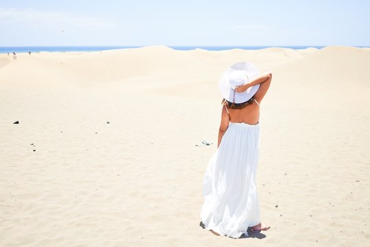Young beautiful woman smiling happy enjoying summer vacation at maspalomas dunes beach