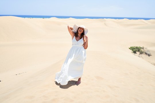 Young beautiful woman smiling happy enjoying summer vacation at maspalomas dunes beach