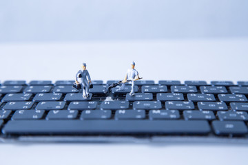 miniature people keyboard black repair, Concept: working in technical teams, technology systems, Behind the maintenance engineering, Computer Hardware Hardware for Laptops, closeup mini top view