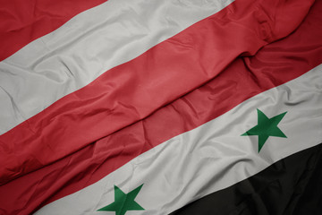 waving colorful flag of syria and national flag of austria.