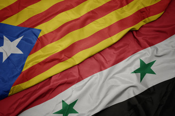 waving colorful flag of syria and national flag of catalonia