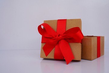 Opened Christmas gift box with red bow.