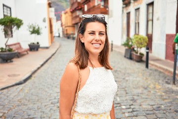 Young beautiful woman on romatic village walking on the town street on a sunny day