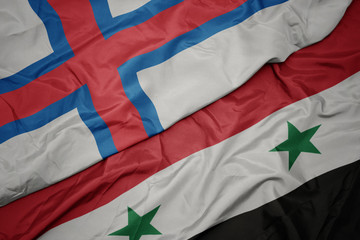 waving colorful flag of syria and national flag of faroe islands.