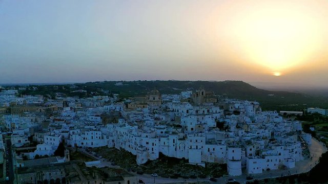 aerial view, flight at  at dusk, Mountain village, Ostuni, Apulia, Southern Italy